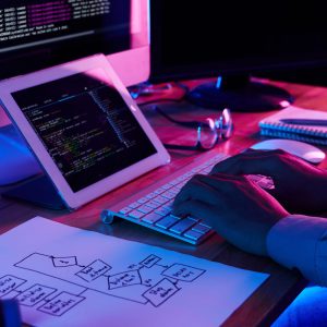 Close-up image of programmer working at his desk in office